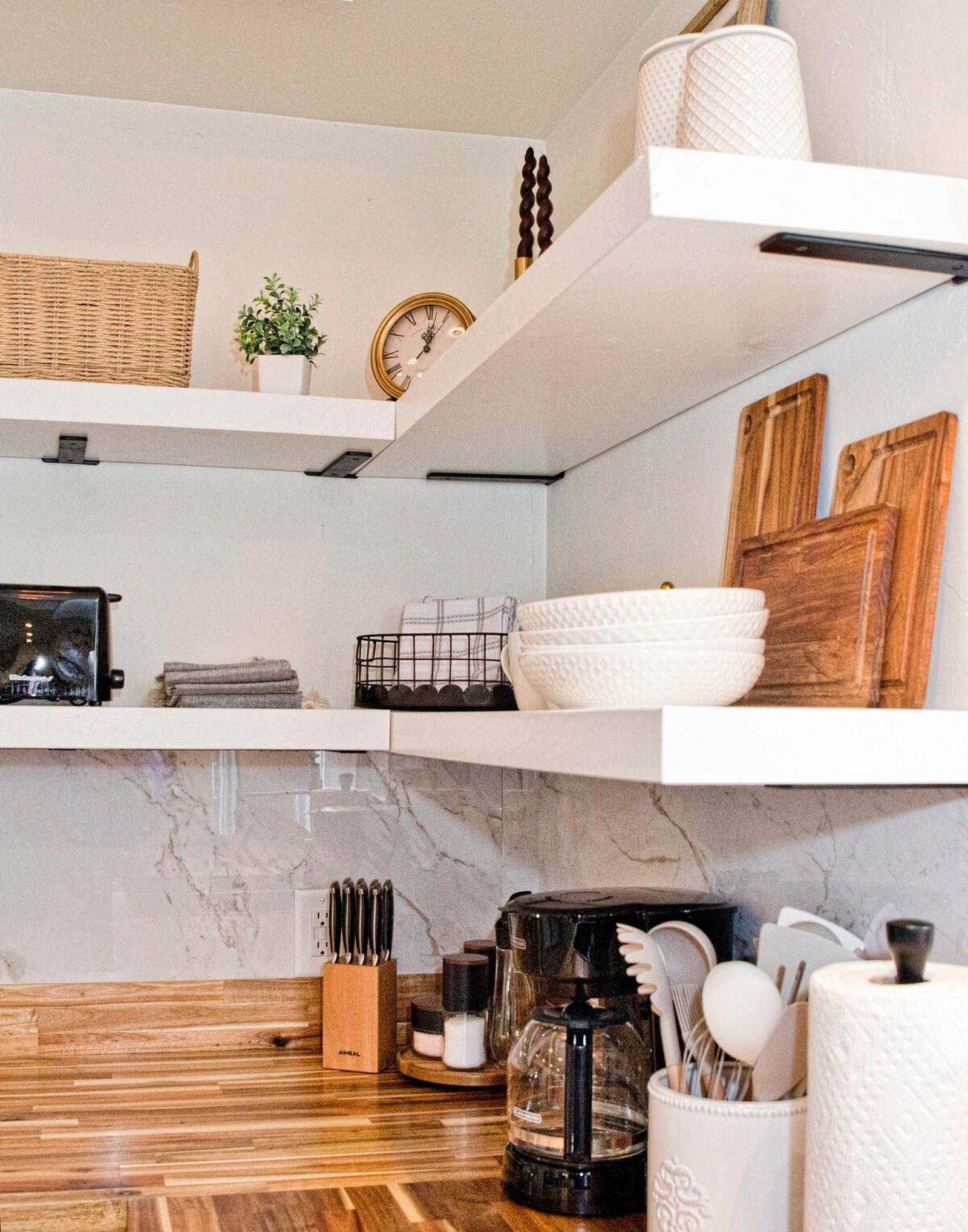 Completed kitchen detail with open shelving, white tile and wood countertops.