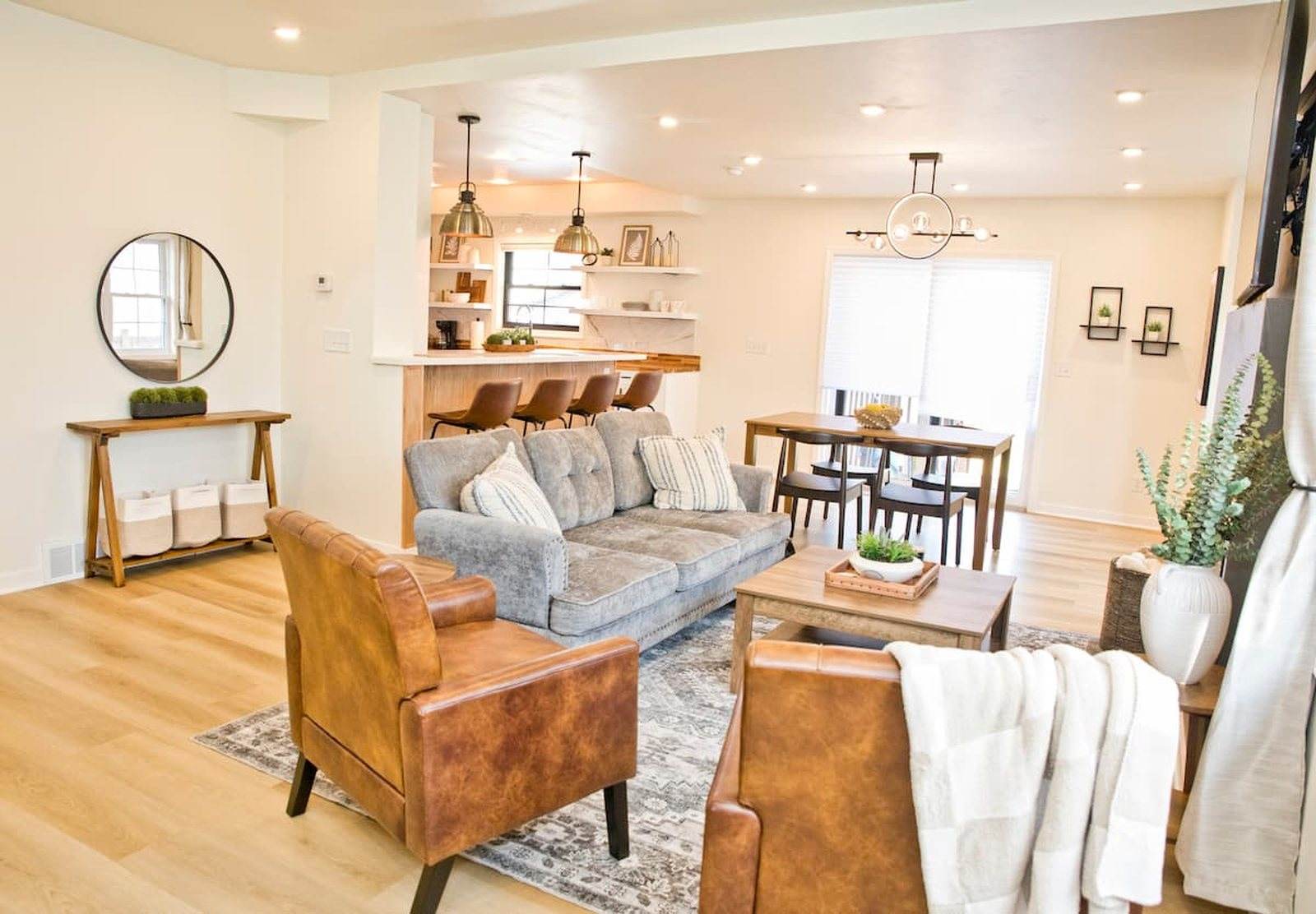 Completed Appleton home with an open living room, dining area and kitchen finished in light wood and white.