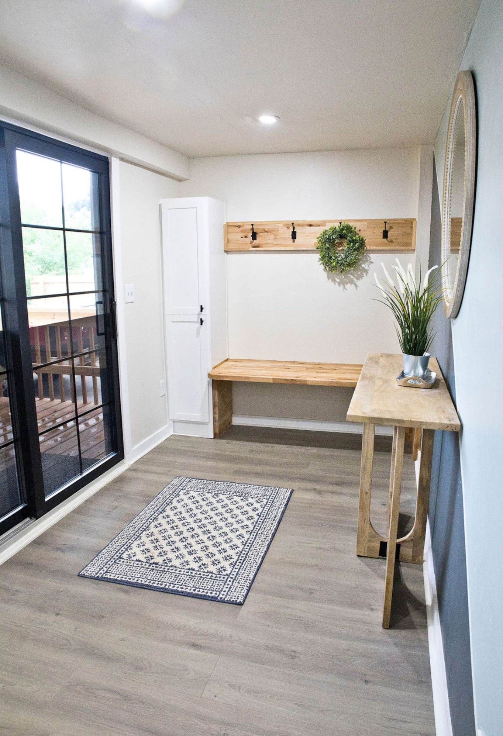 After: entry with a built-in timber bench, coat hooks and a glazed exterior door.