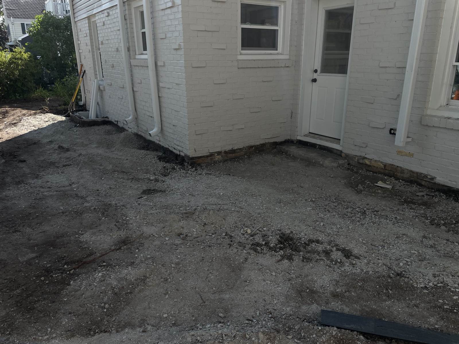 During construction: gravel prepared around the rear doorway and the base of the painted brick walls.