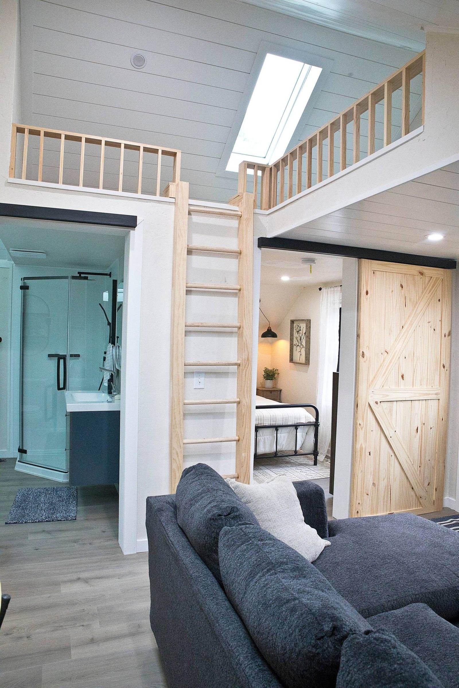 After: timber loft railing above the upper living area, with a ladder and white ceiling boards.
